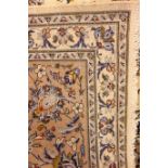 Persian Kashan ivory ground rug, trailing floral pattern with central medallion, repeating border,