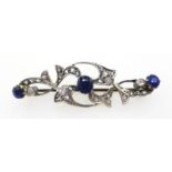 Early 20th century brooch set with three principal sapphires and two diamonds with diamond set