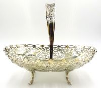 Silver fruit basket scroll fretwork design on four splay feet with swing handle by Lee & Wigfull