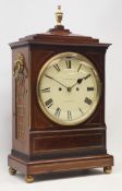 Regency figured mahogany bracket clock, stepped sarcophagus top with turned brass finial,