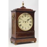 Regency figured mahogany bracket clock, stepped sarcophagus top with turned brass finial,