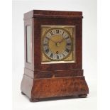 20th century amboyna library clock, stepped case with shaped plinth, on turned bun feet,