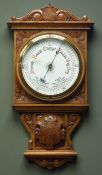 Early 20th century oak case aneroid barometer, carved scrolls and floral spandrels,