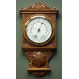 Early 20th century oak case aneroid barometer, carved scrolls and floral spandrels,