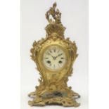 Early 20th century French gilt metal cartouche mantel clock, circular Roman dial,