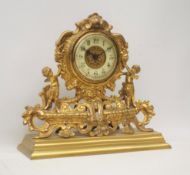 Late 19th century gilt metal mantel clock, ornate cartouche shaped with putto figures,