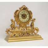 Late 19th century gilt metal mantel clock, ornate cartouche shaped with putto figures,