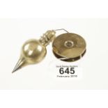 A 3 1/2" steel tipped brass plumb bob with double knurled screw on boxwood reel G+