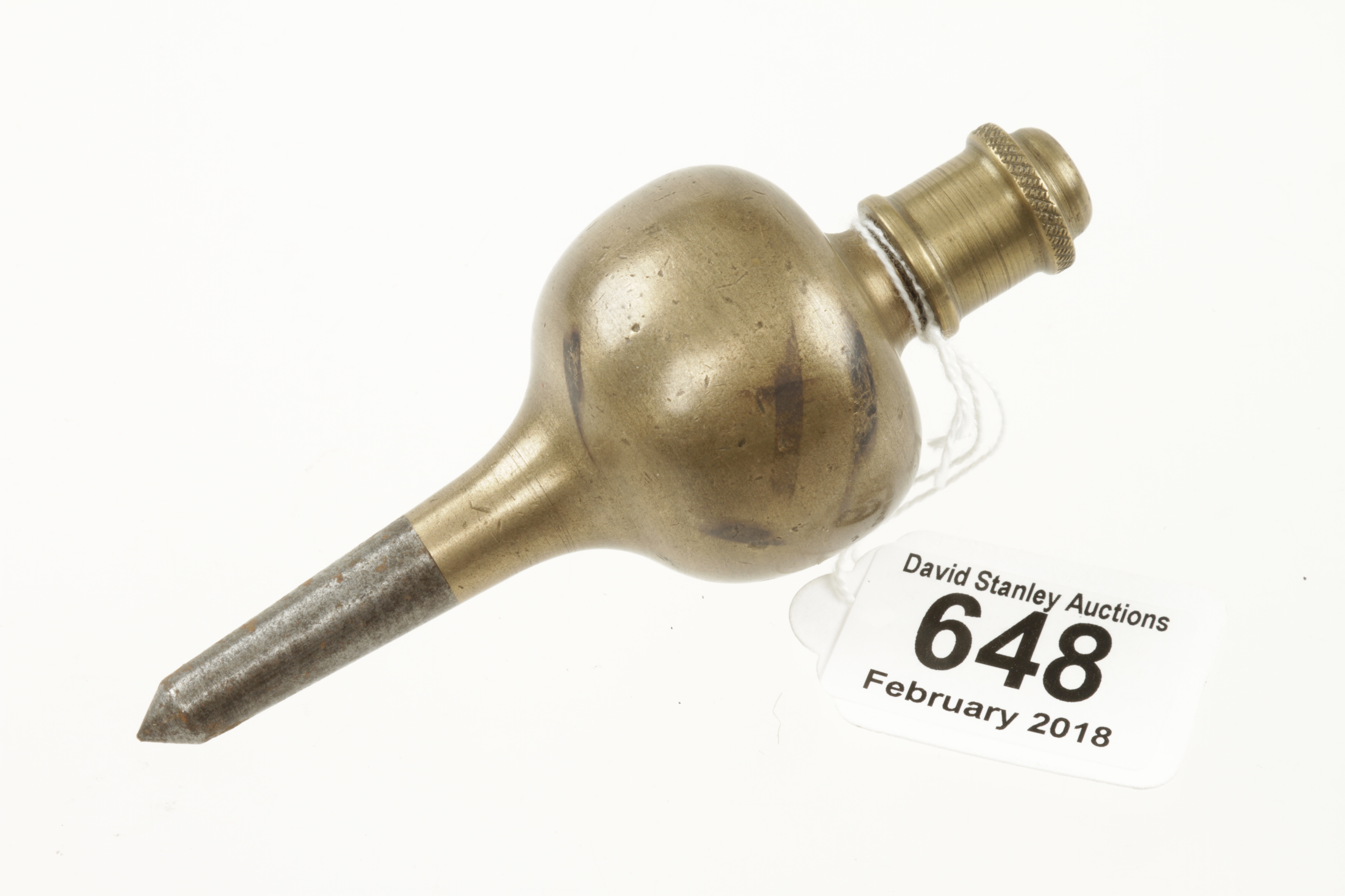 A 5" brass plumb bob with knurled screw