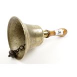 A cast brass ARP WW2 hand bell with beech handle marked FIDDIAN used to signal the end of a