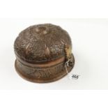 A betel nut copper tin with six other nut or spice tins with floral decoration and a betel nut