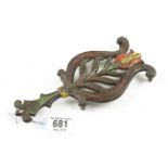 A pretty iron trivet with painted decoration G+