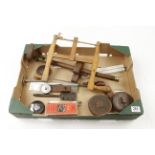 A box of tools incl bow saws, four tapes,
