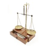 A take down balance by AVERY with brass pans and various weights contained in mahogany drawer/base