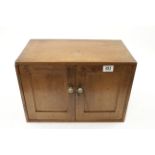 A three drawer oak chest with lockable cupboard doors 17 1/2" x 10" x 12" containing various