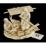 An ivory okimono of two men building a s