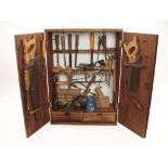 A wall hanging tool cabinet with some tools G