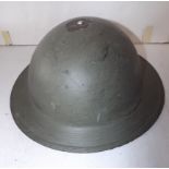 A British WWII helmet, lacks rim rivet from top, the liner is present with good strap.