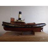 A hand made model of a Falmouth tug "St Denys" of wood construction with planked deck.