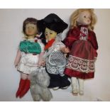 Three dolls and a small toy.