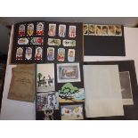 Cigarette cards and a scrap album containing cards and cuttings.