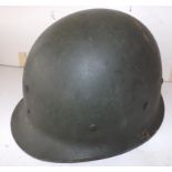 A U.S.A. helmet, condition good, metal fittings, straps worn.
