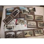 A collection of postcards in five small albums and loose including some Cornish.