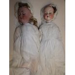 An Armand Marseille porcelain head doll, length 23" and one other shorter similar German doll.