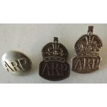 Two hall marked silver A.R.P. badges and a button.
