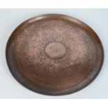 A Newlyn hammered copper circular tray, impressed 'Newlyn', diameter 30cm.