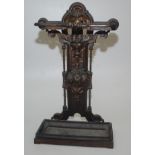A Victorian iron stick stand cast with the head of a woman above leaves and fruit, height 73cm,