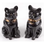 A pair of Jackfield Staffordshire figures of seated cats, late 19th century, with glass eyes,