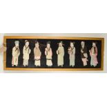 A Chinese embroidered panel, depicting eight raised silk figures, most bearing gifts,