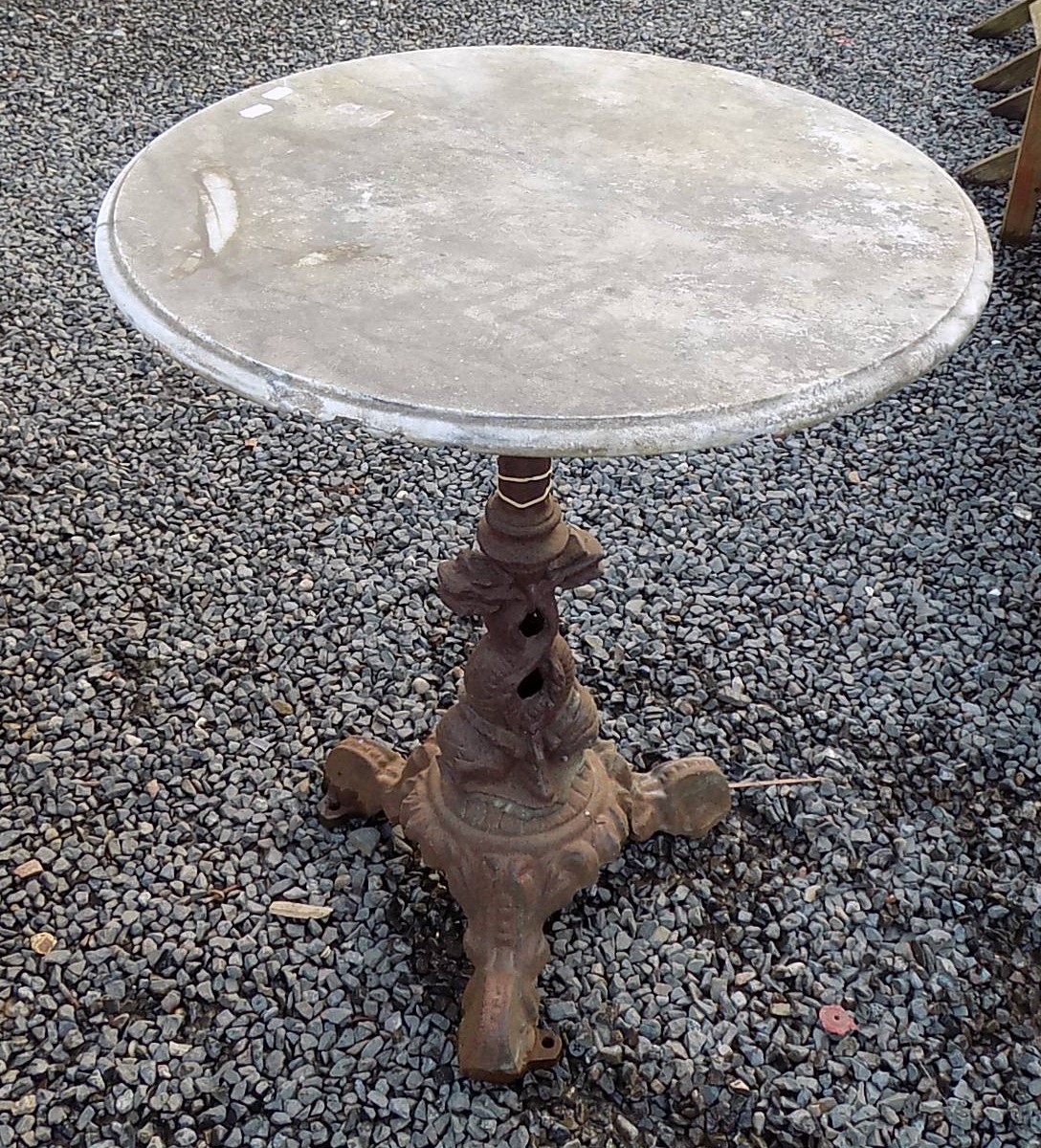 A cast iron and marble topped circular garden table, height 73cm, diameter 59cm.