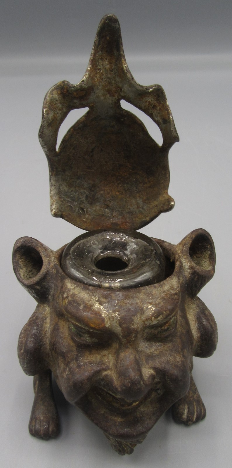 A cast iron inkwell in the form of a gargoyle, with glass liner, height 7.5cm, width 6.5cm, depth 8. - Image 2 of 3