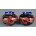 A pair of Moorcroft pottery pomegranate vases, impressed marks to base, heights 7cm.