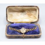 A ladies gold cased wristwatch.