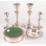 Two pairs of filled silver candlesticks,