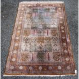 A Persian silk rug, with signature cartouche to the centre top guard stipe,