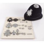 A collection of Devon and Cornwall constabulary badges and a police helmet.