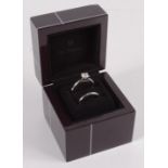 A De Beers platinum engagement ring set a solitaire diamond of approximately 0.