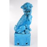 A turquoise porcelain dog of fo, on a rectangular plinth, height 41cm, width 15.5cm, depth 9.5cm.