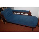 A Victorian walnut upholstered chaise longue, the leaf carved back with five turned spindles,