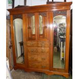 An Edwardian carved walnut triple wardrobe,