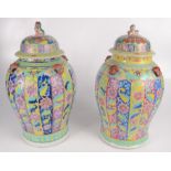 A near pair of Chinese famille jaune porcelain vases and covers, late 19th century,