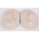A pair of contemporary oval wall plaques of classical maidens,