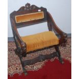 A continental carved walnut armchair, late 19th century, with lions mask arms and paw feet.