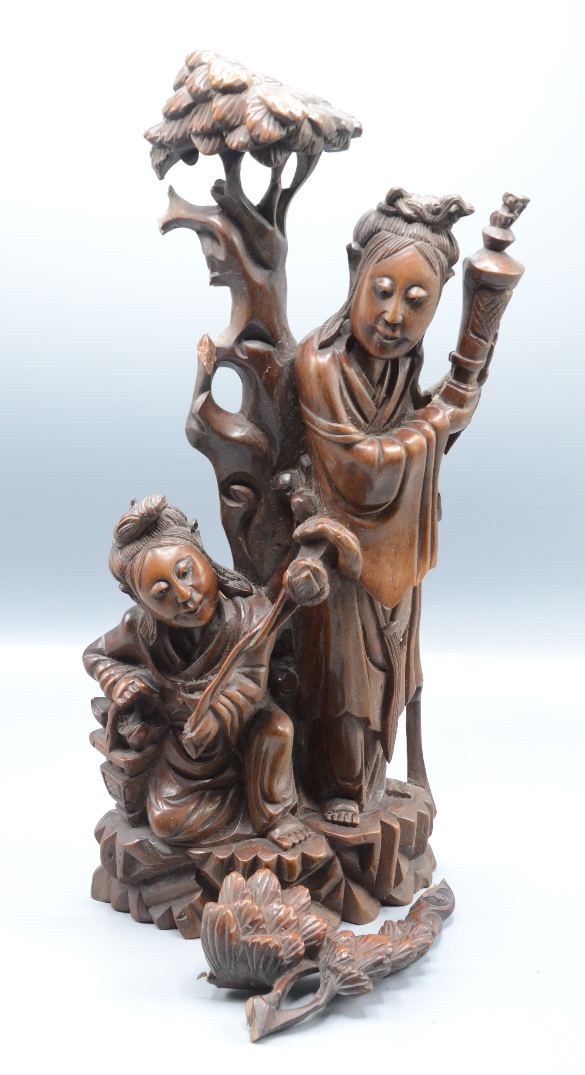 A Chinese carved hardwood figure of a mother and child beside a tree, 19th century, height 44.