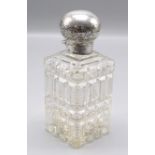 A cut glass late Victorian square section toilet bottle with hinged silver lid and cut glass inner