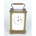 A brass carriage clock, late 19th century, inscribed 'Presented to the Rev F.